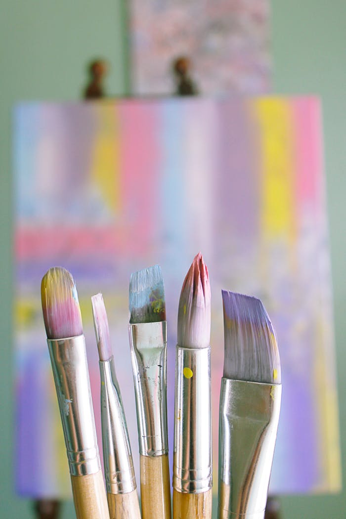 our-services-3 Art brushes with abstract painted canvas in vibrant colors.
